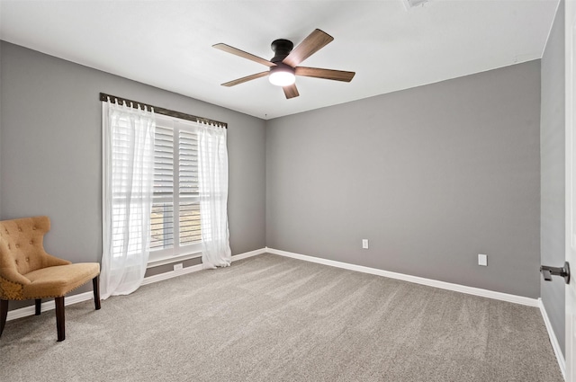 sitting room with carpet, ceiling fan, and baseboards