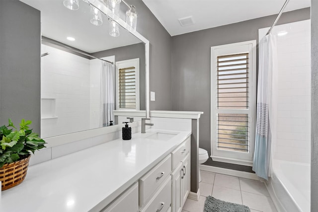 full bathroom featuring tile patterned flooring, toilet, vanity, visible vents, and shower / bath combo