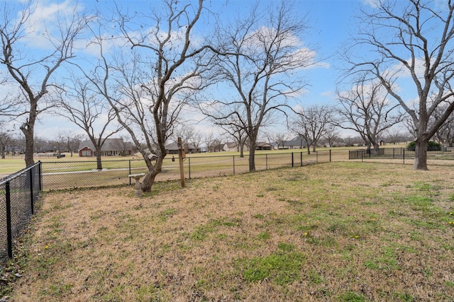 view of yard with a rural view and fence