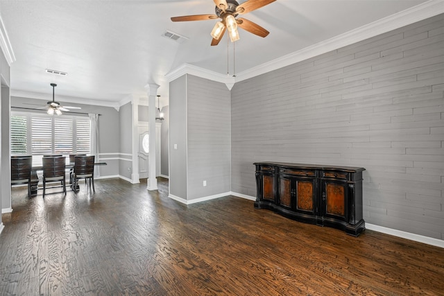 living area featuring dark wood-style floors, decorative columns, visible vents, and ornamental molding