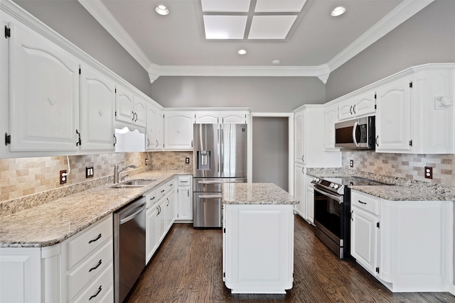 kitchen with light stone counters, dark wood-type flooring, a sink, white cabinets, and appliances with stainless steel finishes