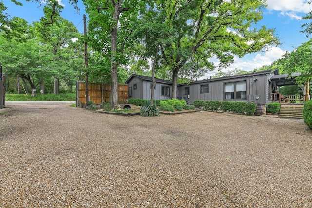 view of front of house featuring fence and board and batten siding