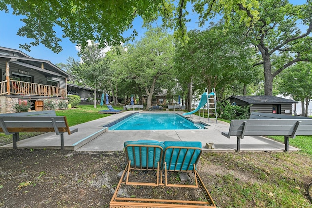 outdoor pool featuring a patio area and a water slide