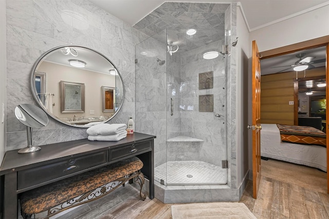 bathroom featuring a stall shower, ornamental molding, wood finished floors, ensuite bathroom, and vanity