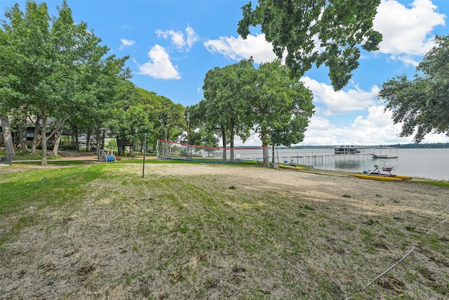 view of yard with a water view and volleyball court