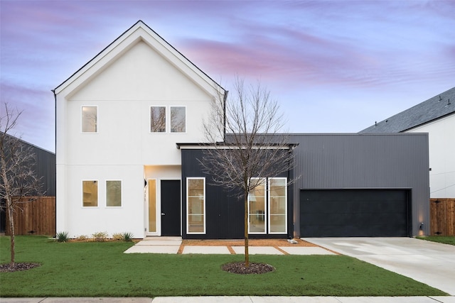 exterior space featuring driveway, an attached garage, a yard, and fence