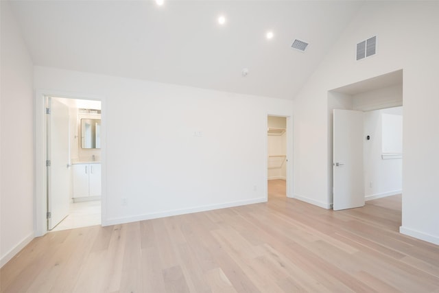 unfurnished room with light wood finished floors, visible vents, and baseboards