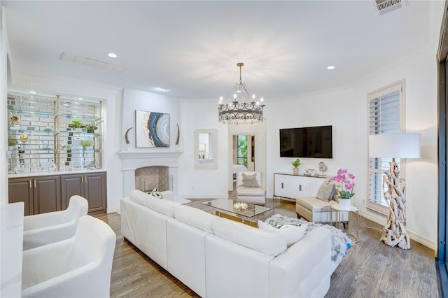62 Cypress Ct, Trophy Club, TX 76262 - living room with a chandelier, wood finished floors, ornamental molding, a fireplace, and recessed lighting