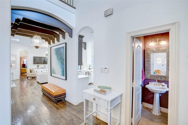 62 Cypress Ct, Trophy Club, TX 76262 - corridor featuring arched walkways, beam ceiling, wood finished floors, and baseboards