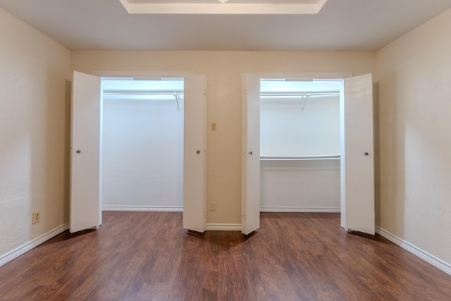 unfurnished bedroom featuring baseboards and wood finished floors