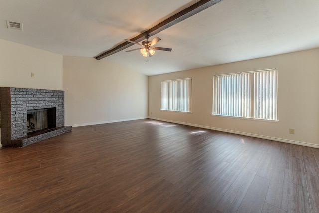 unfurnished living room featuring vaulted ceiling with beams, a brick fireplace, visible vents, and dark wood finished floors