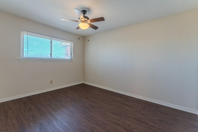 unfurnished room with ceiling fan, baseboards, and dark wood-type flooring