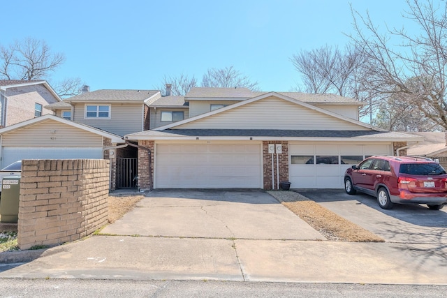 view of front of property featuring brick siding, driveway, and an attached garage