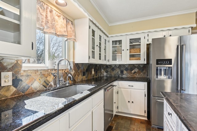 kitchen featuring brick floor, stainless steel appliances, decorative backsplash, ornamental molding, and a sink