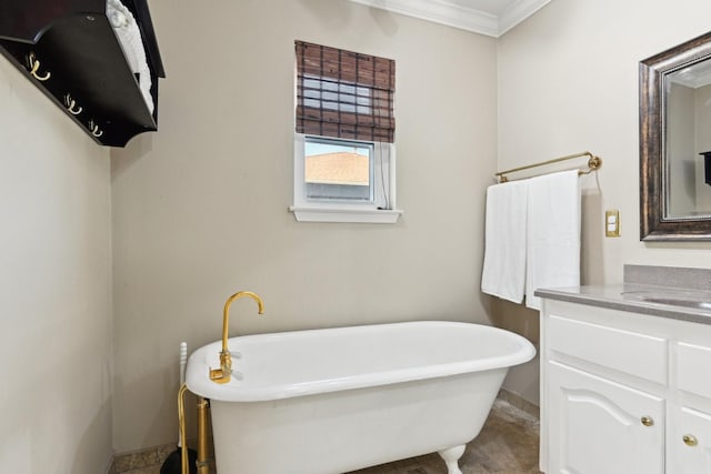 bathroom featuring a freestanding tub, ornamental molding, and vanity