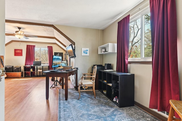 home office with ceiling fan, baseboards, wood finished floors, and lofted ceiling