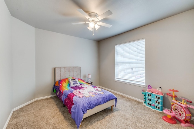 carpeted bedroom featuring a ceiling fan and baseboards