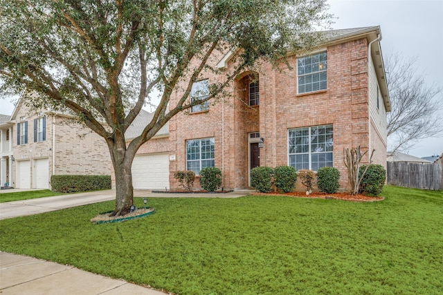 view of front of house with driveway, brick siding, a front lawn, and fence