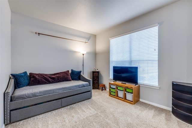 carpeted living room with baseboards