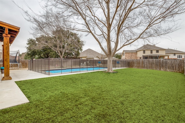 view of yard featuring a fenced backyard, a trampoline, a fenced in pool, and a patio