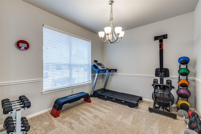 workout room with carpet floors, a notable chandelier, and baseboards