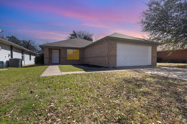 ranch-style house with brick siding, concrete driveway, an attached garage, central AC unit, and a front lawn