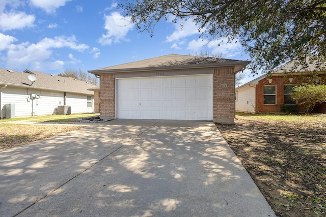 garage featuring concrete driveway