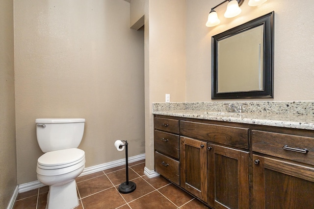 half bath featuring toilet, tile patterned flooring, baseboards, and vanity