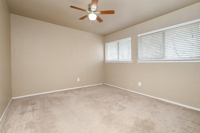 unfurnished room featuring carpet, a ceiling fan, and baseboards