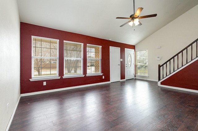 foyer entrance with stairs, wood finished floors, a ceiling fan, and baseboards