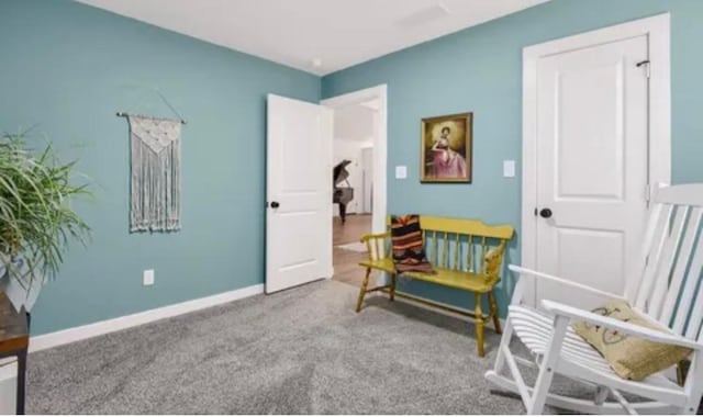 sitting room with carpet flooring and baseboards