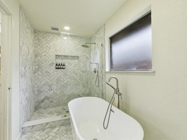 bathroom with a freestanding tub, visible vents, a walk in shower, and recessed lighting