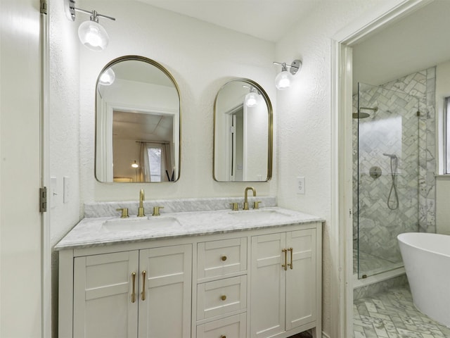 full bath with a stall shower, a soaking tub, a sink, and double vanity