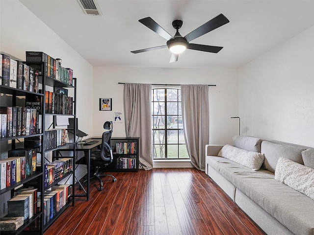 home office featuring wood-type flooring, visible vents, and a ceiling fan