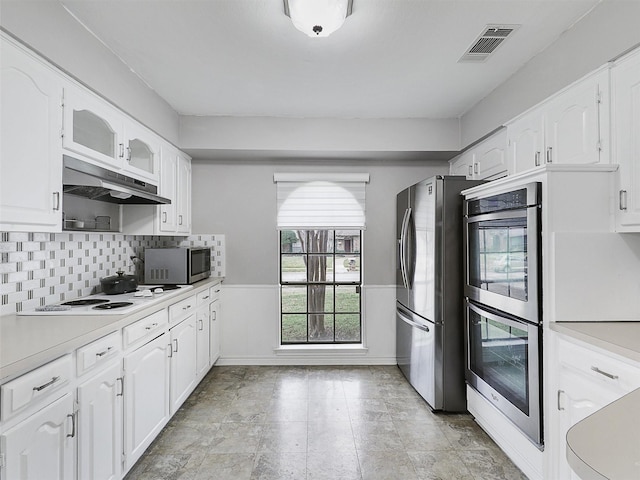 kitchen with white cabinets, under cabinet range hood, visible vents, and stainless steel appliances