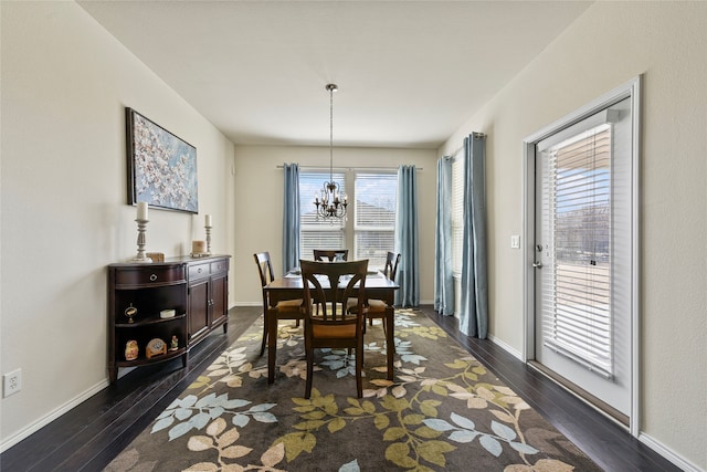 dining space with an inviting chandelier, dark wood-style floors, and baseboards