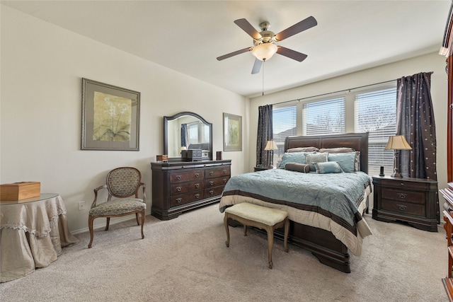 bedroom featuring light colored carpet and ceiling fan