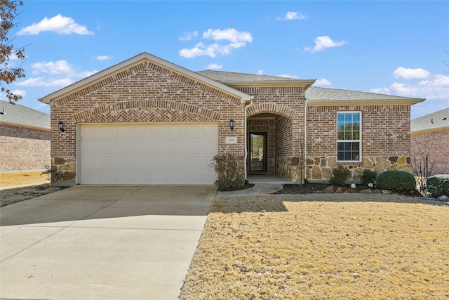 view of front of home with stone siding, roof with shingles, concrete driveway, an attached garage, and brick siding