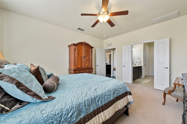 bedroom featuring visible vents, light colored carpet, and a ceiling fan