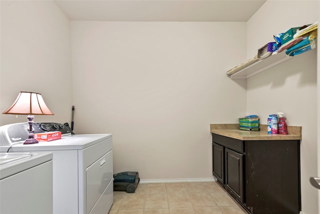 laundry area with washer and dryer, light tile patterned flooring, and baseboards