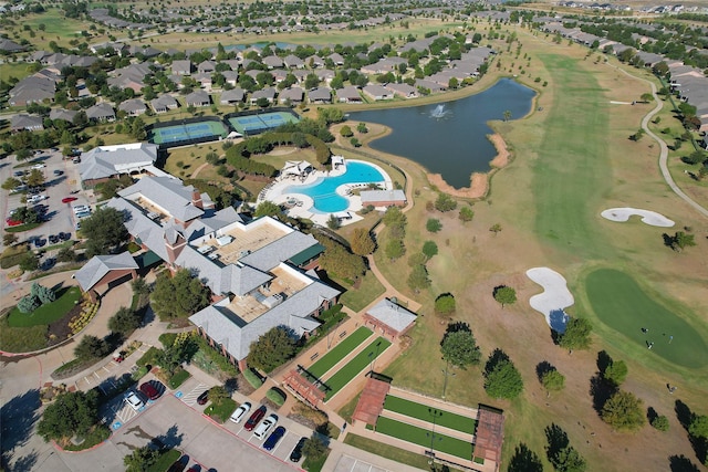 drone / aerial view with a residential view, a water view, and view of golf course