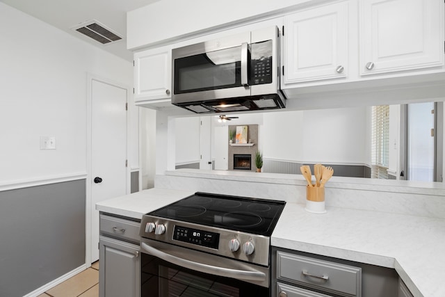 kitchen with visible vents, stainless steel appliances, light countertops, and gray cabinetry