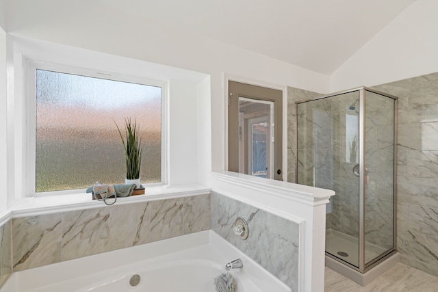 bathroom featuring lofted ceiling, a stall shower, and a bath