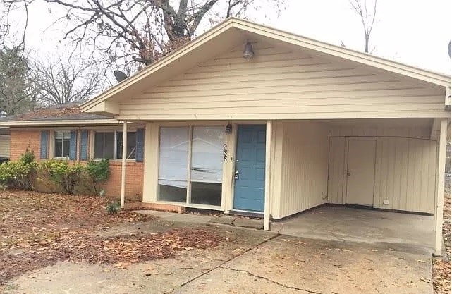 exterior space featuring brick siding and an attached carport