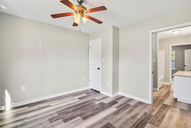 unfurnished bedroom with light wood-type flooring, baseboards, and a ceiling fan