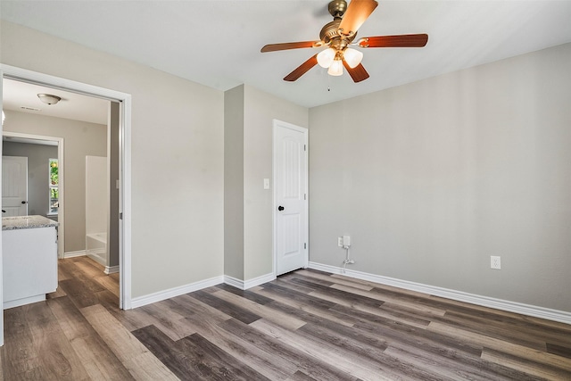 unfurnished room featuring a ceiling fan, baseboards, and wood finished floors