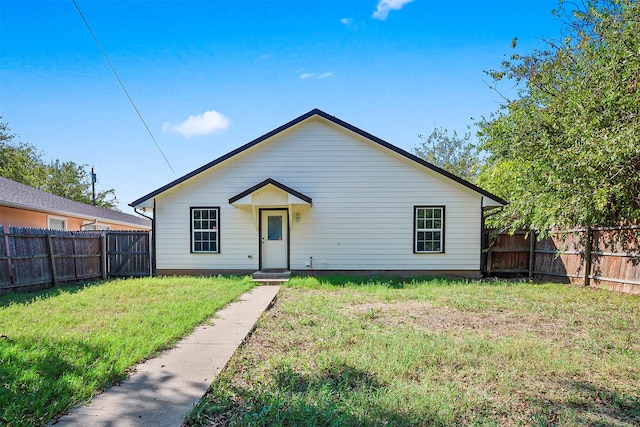 bungalow-style home featuring a front yard and fence