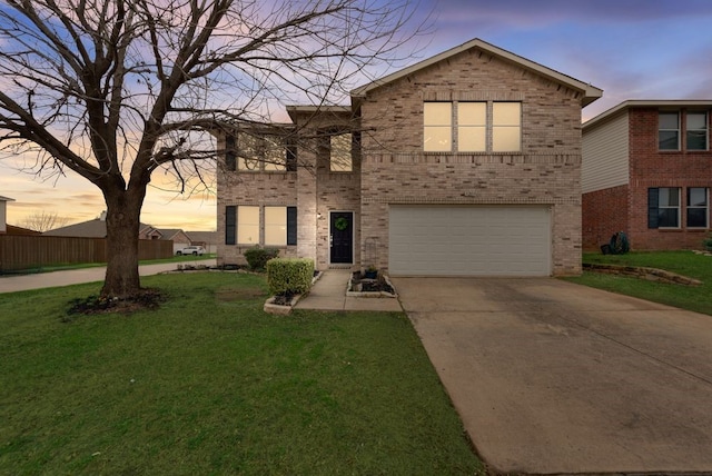 traditional home featuring a front yard, brick siding, driveway, and an attached garage