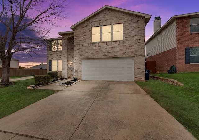 traditional home featuring driveway, a garage, a front lawn, and brick siding