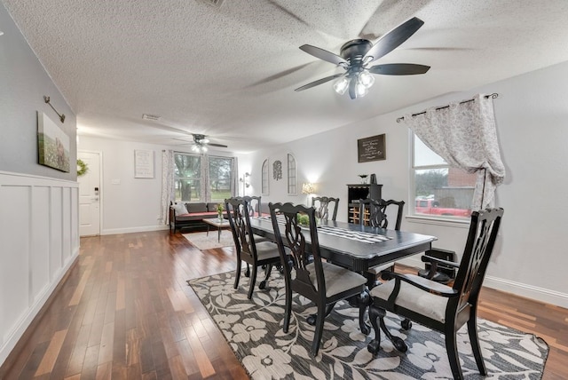 dining area featuring a textured ceiling and wood finished floors